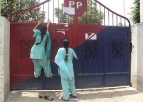 Two of the protesting girls try to enter the police station in Faridkot on Sunday