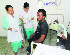 Some of the injured pilgrims receive treatment at the Tanda Medical Hospital in Kangra on Saturday night.