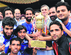 Chief Minister Omar Abdullah poses for a photograph with J&K-XI after it defeated Mohammedan Sporting Club in a friendly match in Srinagar on Sunday.