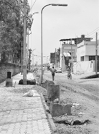 Electricity poles placed on road instead of footpath at Phase VII in Mohali. Tribune photo: Vicky Gharu