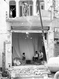 Shopkeepers demolish the front side of their shops to leave space for parking as per court order on the Patiala highway at Zirakpur on Monday. Tribune Photo: Nitin Mittal