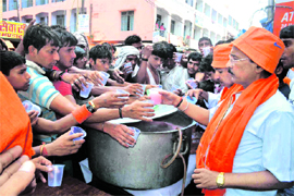 Employees of the Bank of India offer juice and refreshments to Kanwariyas on the bank premises in Haridwar on Monday. 