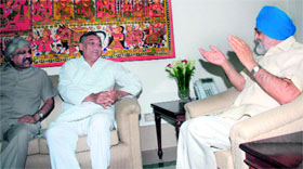 Chief Minister Vijay Bahuguna with Deputy Chairman of the Planning Commission Montek Singh Ahluwalia in New Delhi on Monday.