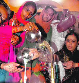 Faith in full flow: Devotees offer milk to Lord Shiva at a temple in Shimla on Monday. The day marked the beginning of Shravan.