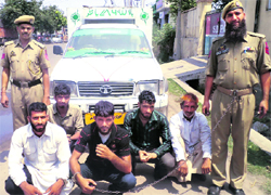 The police with the five accused arrested for bovine smuggling. A Tribune photograph