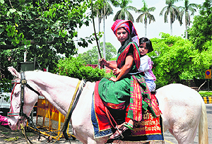  Sunita Chaudhary, a woman auto-rickshaw driver, poses for photographs as she leaves to file nomination for the post of the countrys Vice-President in New Delhi on Monday.