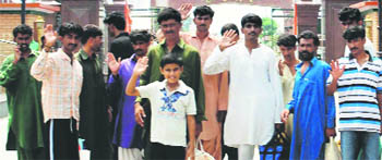 Pakistani prisoners, including a 10-year-old boy, wave before crossing over to Pakistan at Attari-Wagah Joint Check Post on Tuesday. 