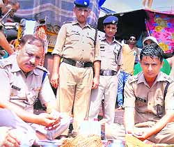 SSP Arun Mohan Joshi (right) and the Kanwar mela police chief, SP K Lal Shaw, perform rituals at Brahamkund, Har-ki-Pauri, on the peaceful completion of the fortnight-long Kanwar pilgrimage in Haridwar on Tuesday