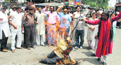 Workers of the UKD (P) burn an effigy of BJP legislator Harbhajan Singh Cheema in Dehradun on Tuesday. 