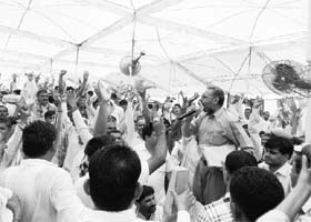 An NGO activist asks a question as farmers try to disrupt the proceedings during a hearing on green impact of the upcoming nuclear power plant at Gorakhpur in Fatehabad