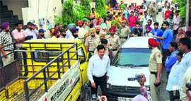 Police officials, including the Commissioner of Police, at Punjab Mata Nagar near Pakhowal Road where the double murder took place on Tuesday.