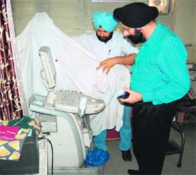 Health department officials seal an ultrasound machine at a private hospital in Amritsar