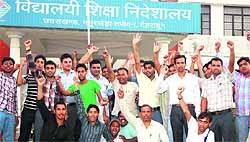 Teachers stage a demonstration in front of the Education Directorate in support of their demands in Dehradun on Wednesday