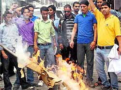 ABVP workers burn an effigy of the state government in Mussoorie on Wednesday