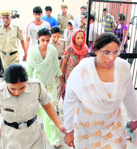 Jaswanti Devi (in white suit) and nine other accused in the Apna Ghar case are produced in the CBI court at Panchkula on Wednesday. Tribune photo: Nitin Mittal