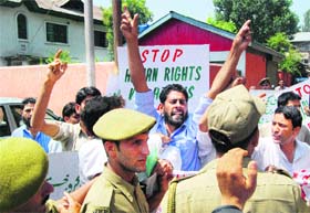Chairman of the Jammu and Kashmir Peoples Freedom League Rafiq Ahmad Ganaie protests against human rights violations, in Srinagar on Wednesday