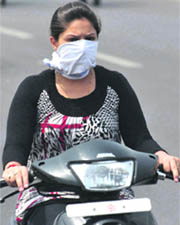 A girl protects her face from the blazing sun in Jammu on Wednesday. 