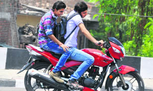 Throwing norms to the wind, youths ride on a motorcycle without helmets in Jammu.