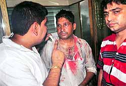 Ashwani Kumar (centre) being thrashed by shopkeepers at Lal Bazaar in Jalandhar on Tuesday evening