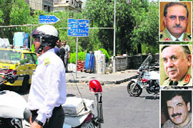 Policemen guard the road near the scene of Wednesdays attack that killed Defence Minister General Daoud Rajha, former minister General Hassan Ali Turkmani, President Bashar al-Assads brother-in-law Assef Shawkat (inset) in the heart of Damascus.