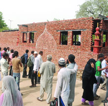 People gather to see the construction of mosque near the Jama Masjid in New Delhi on Thursday. 