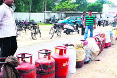 Consumers line up way at a gas agency outlet in BHEL in Haridwar on Thursday. 