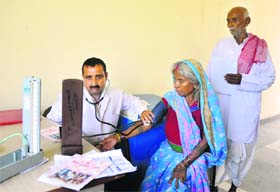 A doctor examines a pilgrim during a medical camp at the Bhagwati Nagar base camp in Jammu