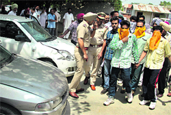 Members of the gang of car snatchers, nabbed by the police, being brought for a press conference in Jalandhar on Thursday.