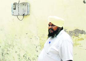 A resident stands near the box from where the electricity meter was stolen at Jagraon