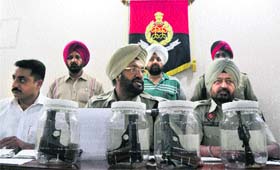 Police officials show the pistols recovered from the accused in Ludhiana on Thursday