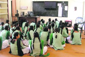 Students of a government school sit idle in an EduSat laboratory during a power cut