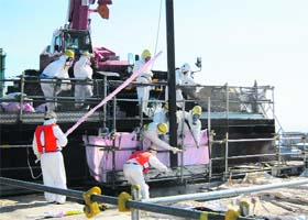 Workers removing unused nuclear fuel assemblies in Fukushima Daiichi nuclear plant on Thursday