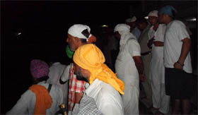 Devotees look on while a diver locates the boys in the sarovar at Gurdwara Tarantaran Sahib in Muktsar on Friday evening. 