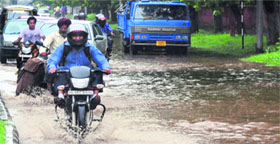 Vehicles moving on an inundated road separating Sectors 28 and 29.