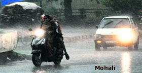 Residents had to turn on their vehicle lights after it became very dark due to rain in Phase I, Mohali, on Friday.