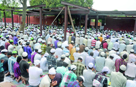 Muslims offer prayers at the mosque site at Subhash Park in Delhi on Friday.