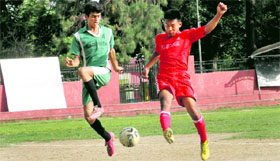 Players in action in a match during the 3rd ONGC-BS Negi Memorial Football Tournament under way at Ambedkar Stadium in Dehradun on Friday.