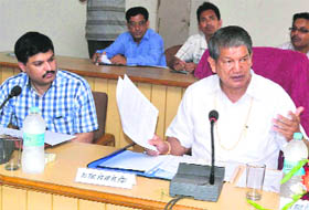Union Minister of State for Agriculture Harish Rawat presides over a meeting of governmnet officials in Haridwar on Friday. 