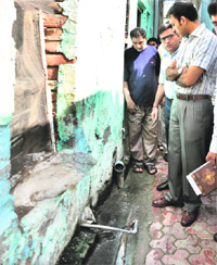 Deputy Commissioner Priyank Bharti checks water connections in the Manjit Nagar area, affected with diarrhoea outbreak, in Jalandhar on Friday. 