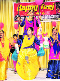 Students of the St Soldier Group of Institutes enjoy swings at a Teej fair in Jalandhar.