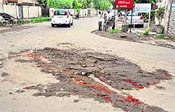 The portion of a city road that caved in after the rain
