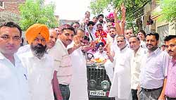 Newly elected MC chief and vice-president head a procession with their supporters at Amloh on Friday