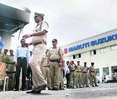 Police personnel at the violence-hit plant on Friday. 