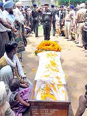 An Army personnel salutes and pays homage to the body of the slain soldier, Govind Singh, who died after being attacked by terrorists in Kupwara in J&K