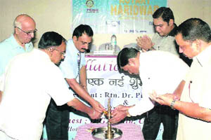 Members of the Rotary Club light a traditional lamp at their meeting in Haridwar on Saturday.