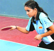 Tina Rawat of Summer Valley School plays a shot during a match in Dehradun on Saturday.