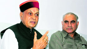 CM PK Dhumal with PWD Minister Gulab Singh Thakur at a press conference in Mandi on Saturday.