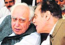 State Congress chief Saifuddin Soz interacts with Union Minister Kapil Sibal during a rally at the party headquarters in Srinagar on Saturday. 