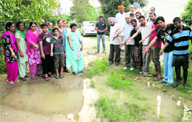 Residents of the Carol Bagh area in Jalandhar show a water-clogged road after light rain in the area.