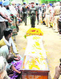 Army officers pay tributes to martyr Govind Singh at Sivian village in Bathinda.